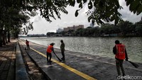 Sanksi sosial bagi para pelanggar adalah menyapu sampah di kawasan Danau Sunter.