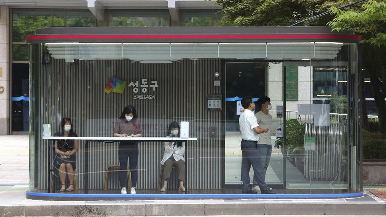 Halte Bus Canggih di Korea Selatan A bus shelter designed to block people with fever amid a spread of the coronavirus, is installed at a bus stop in Seoul, South Korea, Friday, Aug. 14, 2020. The glass panels-covered bus stops at a Seoul district, are equipped with thermal cameras that screen people for fevers and also automatic doors that doesn’t let in any one with high temperatures. (AP Photo/Ahn Young-joon)
