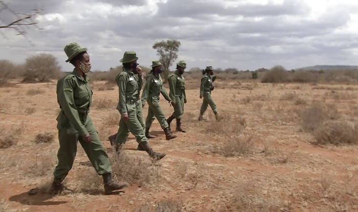 Kenya Women Wildlife Rangers In this image made from video, female wildlife ranger Purity Amleset, 24, left, speaks to a Maasai woman near Amboseli national park, Kenya Friday, Jul. 31, 2020. On the sweeping plains at the foot of Mount Kilimanjaro a group of female wildlife rangers known as