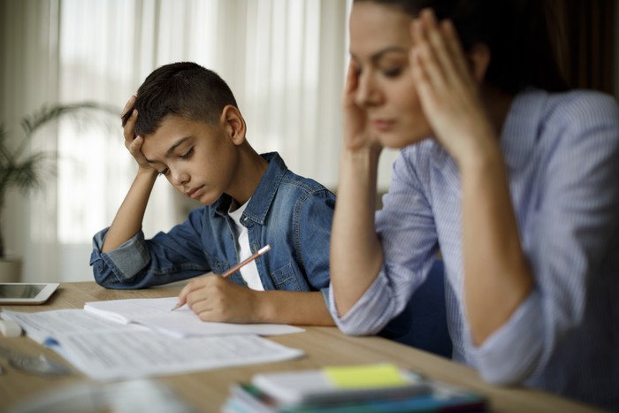 Teenage boy having problems in finishing homework