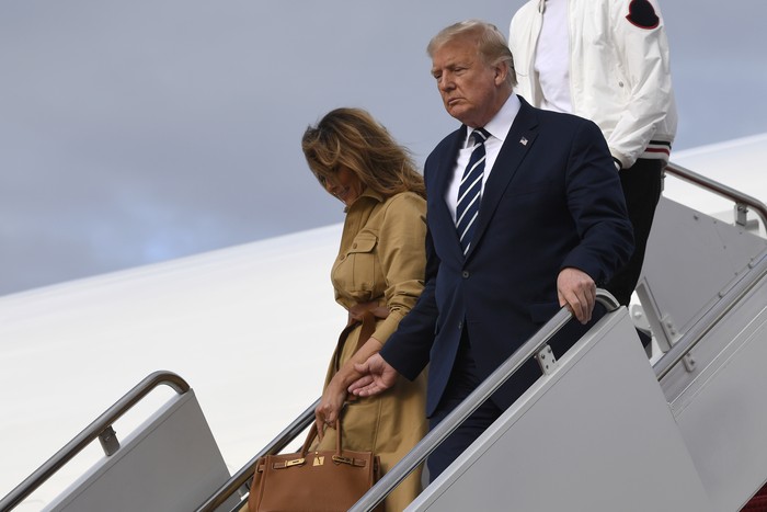 President Donald Trump and first lady Melania Trump walk down the steps of Air Force One at Andrews Air Force Base, Md., Sunday, Aug. 16, 2020. Trump was returning to Washington after spending the weekend at Trump National Golf Club in New Jersey. (AP Photo/Susan Walsh)