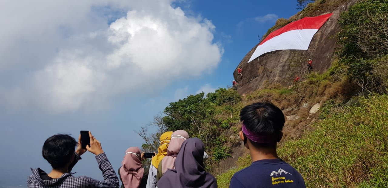 Merayakan HUT RI ke-75 sebuah bendera Merah Putih raksasa dibentangkan di tebing Gunung Bongkok, Purwakarta. Seperti apa?