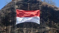Pegiat panjat tebing membentangkan Bendera Merah Putih di Bukit Gundil, Desa Sanenrejo, Tempurejo, Jember, Jawa Timur, Senin (17/8/2020). Pembentangan bendera merah putih berukuran 8 x 6 meter tersebut untuk memperingati HUT ke-75 Republik Indonesia. ANTARA FOTO/Seno.