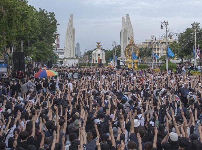Pro-democracy students raise three-fingers, symbol of resistance salute, during a rally in Bangkok, Thailand, Sunday, Aug, 16, 2020. Protesters have stepped up pressure on the government if it failed to meet their demands, which include holding of new elections, amending the constitution, and an end to intimidation of critics. (AP Photo/Sakchai Lalit)