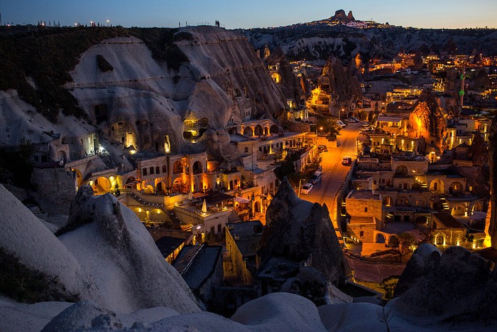 NEVSEHIR, TURKEY - APRIL 18: Tourists look out at the view above a cave hotel on April 18, 2016 in Nevsehir, Turkey. Cappadocia, a historical region in Central Anatolia dating back to 3000 B.C is one of the most famous tourist sites in Turkey. Listed as a World Heritage Site in 1985, and known for its unique volcanic landscape, fairy chimneys, large network of underground dwellings and some of the best hot air ballooning in the world, Cappadocia is preparing for peak tourist season to begin in the first week of May.  Despite Turkey's tourism downturn, due to the recent terrorist attacks,  internal instability and tension with Russia, local vendors expect tourist numbers to be stable mainly due to the unique activities on offer and unlike other tourist areas in Turkey such as Antalya, which is popular with Russian tourists, Cappadocia caters to the huge Asian tourist market.  (Photo by Chris McGrath/Getty Images)