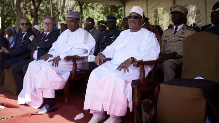 (FILES) In this file photo taken on November 30, 2019 Malian President Ibrahim Boubacar Keita (R) and Malian Prime Minister Boubou Cisse (L) attend the opening of the 12th edition of the Bamako Encounters Photography Biennial. - Gunfire broke out at a key army base near Malis capital Bamako on August 18, 2020, officials and witnesses said, triggering fears of a mutiny in the crisis-stricken Sahel state.  
Details of the events were sketchy, but the sources said the soldiers fired their guns into the air at a base in Kati, a town some 15 kilometres (nine miles) from Bamako. (Photo by MICHELE CATTANI / AFP)