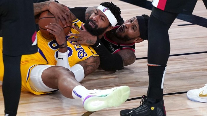 Los Angeles Lakers forward Markieff Morris battles on the floor for a loose ball with Portland Trail Blazers forward Carmelo Anthony , beneath, during the second half of an NBA basketball game Tuesday, Aug. 18, 2020, in Lake Buena Vista, Fla. (AP Photo/Ashley Landis, Pool)