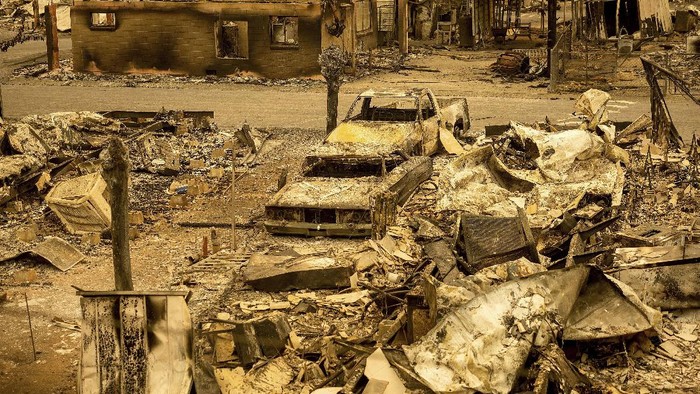 Scorched homes and vehicles fill Spanish Flat Mobile Villa following the LNU Lightning Complex fires in unincorporated Napa County, Calif., on Thursday, Aug. 20, 2020. The fire destroyed dozens of homes at the mobile home park with only a handful that remained standing. Fire crews across the region scrambled to contain dozens of wildfires sparked by lightning strikes. (AP Photo/Noah Berger)