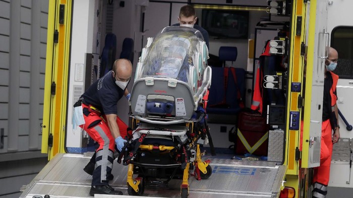 In this photo provided by Alexei Navalny's press team, early Saturday, Aug. 22, 2020, medics upload Alexei Navalny into a German special medical plane at an airport in Omsk, Russia. The dissident who is in a coma after a suspected poisoning has been transferred to an ambulance and is now being driven to an airport in the Siberian city of Omsk. Navalny will be flown to Germany to receive treatment. (Kira Yarmysh/Alexei Navalny's press team via AP)