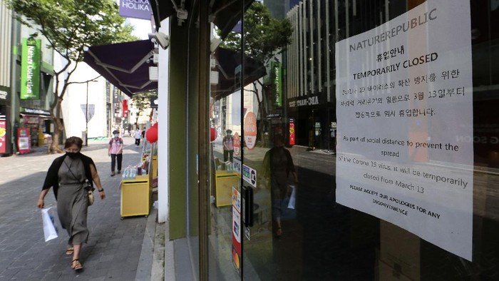A notice is seen at the entrance of a temporarily closed store at a shopping district in Seoul, South Korea, Sunday, Aug. 23, 2020. South Korea has added nearly 400 new coronavirus cases, counting its tenth straight day of triple-digit increases as the speed of viral spread nears the levels the country saw during the worst of its outbreak in spring. (AP Photo/Ahn Young-joon)