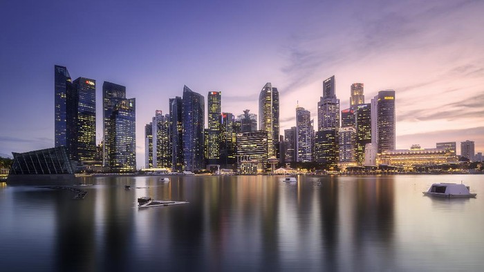 View of downtown district and Marina bay skyline with purple sunrise in Singapore