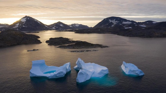 Lapisan Es Greenland Mencair FILE - In this Aug. 16, 2019 file photo, icebergs float away as the sun rises near Kulusuk, Greenland. According to a study released on Thursday, Aug. 20, 2020, Greenland lost a record amount of ice during an extra warm 2019, with the melt massive enough to cover California in more than four feet (1.25 meters) of water. (AP Photo/Felipe Dana, File)