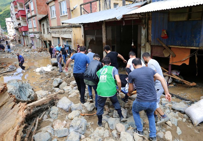 The road has been swept away and debris strewn across the area after floods caused by heavy rain in the mountain town of Dereli in Giresun province, along Turkey's Black Sea coastline, Sunday, Aug. 23, 2020.  Seven people have died other are still missing after flooding around Dereli. (AP Photo)