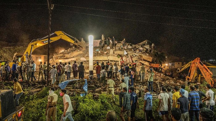 Rescue workers look for survivors after a residential building collapsed in Mahad, about 170 kilometers (105 miles) from Indias financial capital of Mumbai, Monday, Aug. 24, 2020. Many people feared injured and more than 65 were trapped inside after a residential building caved in on Monday evening in the central Indian state of Maharashtra. (AP Photo)
