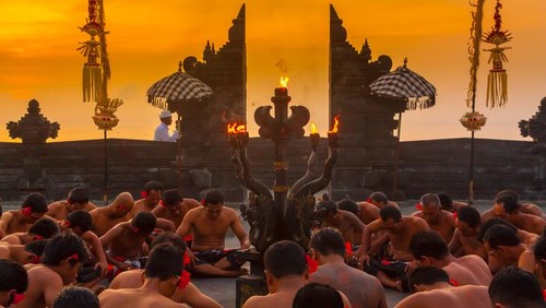 Bali, Indonesia - June 5, 2013: Traditional Ritual Balinese Kecak dance with elements of trance performed by men artists in traditional costumes  at Uluwatu Temple in the evening.