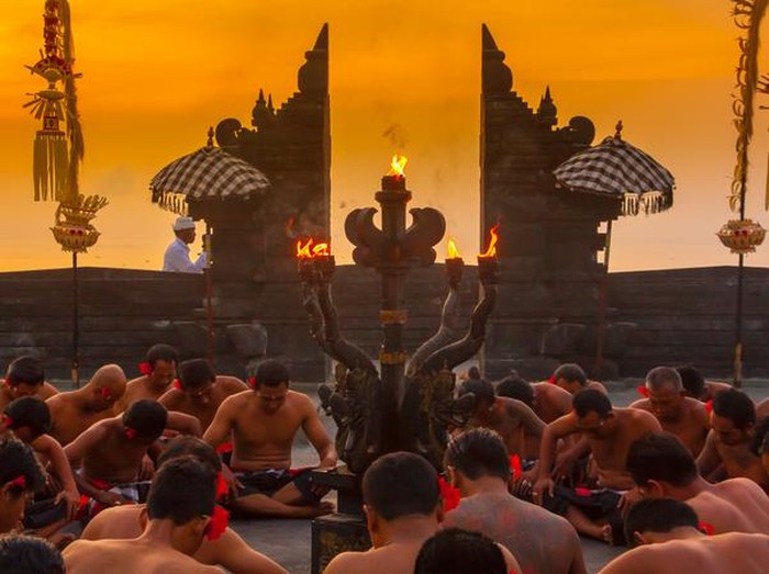 Bali, Indonesia - June 5, 2013: Traditional Ritual Balinese Kecak dance with elements of trance performed by men artists in traditional costumes  at Uluwatu Temple in the evening.