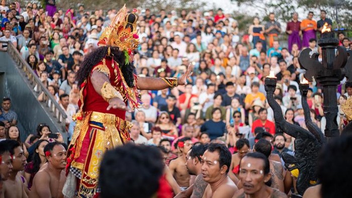 Bali, Indonesia - June 5, 2013: Traditional Ritual Balinese Kecak dance with elements of trance performed by men artists in traditional costumes  at Uluwatu Temple in the evening.