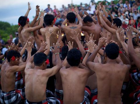 Bali, Indonesia - June 5, 2013: Traditional Ritual Balinese Kecak dance with elements of trance performed by men artists in traditional costumes  at Uluwatu Temple in the evening.