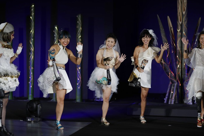 Japan Paralympics Fashion Show Kaede Maegawa, a Paralympian, from second left, Hitomi Onishi, a Paralympian, and Sayaka Murakami, an athlete, pose for a photo at the end of a fashion show dubbed