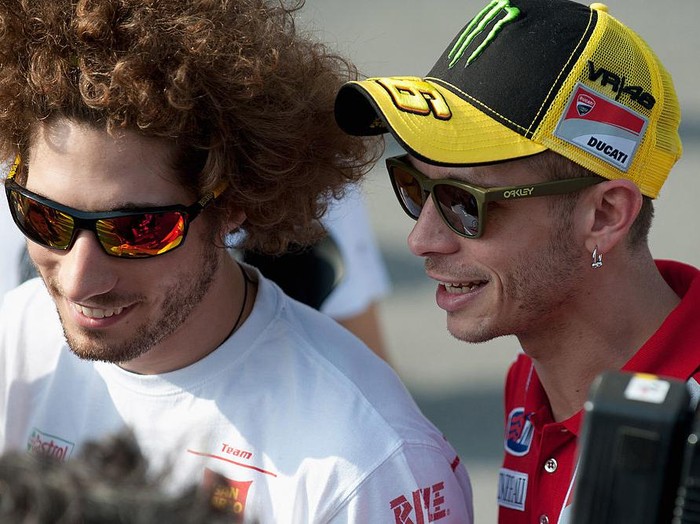 KUALA LUMPUR, MALAYSIA - FEBRUARY 23:  Valentino Rossi of Italy and  and Ducati Marlboro Team speaks with Marco Simoncelli of Italy and San Carlo Honda Gresini before the second day of testing at Sepang Circuit on February 23, 2011 in Kuala Lumpur, Malaysia.  (Photo by Mirco Lazzari gp/Getty Images)