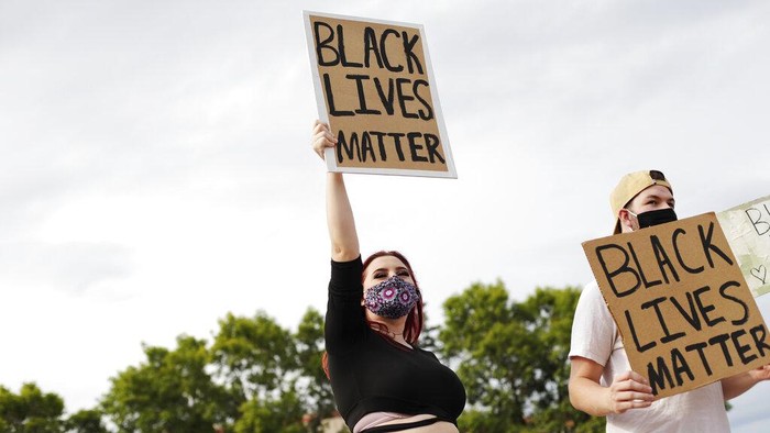 Kenzie Medick, 19, and Patrick Eades, 22, hold Black Lives Matter signs during the Justice for Jacob protest near the south side of the Marathon County Courthouse, Tuesday, Aug. 25, 2020, in Wausau, Wis. (Samantha Madar/The Post-Crescent via AP)