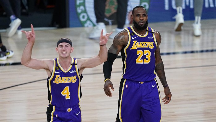 Los Angeles Lakers guard Alex Caruso (4) and forward LeBron James (23) celebrate their win over the Portland Trail Blazers in an NBA basketball first round playoff game, Saturday, Aug. 22, 2020, in Lake Buena Vista, Fla. (AP Photo/Ashley Landis, Pool)