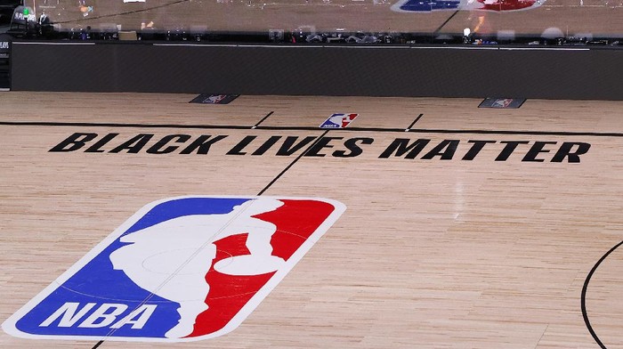 An empty court and bench are shown with no signage following the scheduled start time in Game 5 of an NBA basketball first-round playoff series, Wednesday, Aug. 26, 2020, in Lake Buena Vista, Fla. NBA players made their strongest statement yet against racial injustice Wednesday when the Milwaukee Bucks didn’t take the floor for their playoff game against the Orlando Magic.(Kevin C. Cox/Pool Photo via AP)