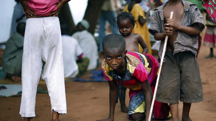 FILE - In this Sunday, Aug. 28, 2016 file photo, a health official administers a polio vaccine to a child at a camp for people displaced by Islamist Extremists, in Maiduguri, Nigeria. Health authorities on Tuesday, Aug. 25, 2020 are expected to declare the African continent free of the wild poliovirus after decades of effort, though cases of vaccine-derived polio are still sparking outbreaks of the paralyzing disease in more than a dozen countries. (AP Photo/Sunday Alamba, File)