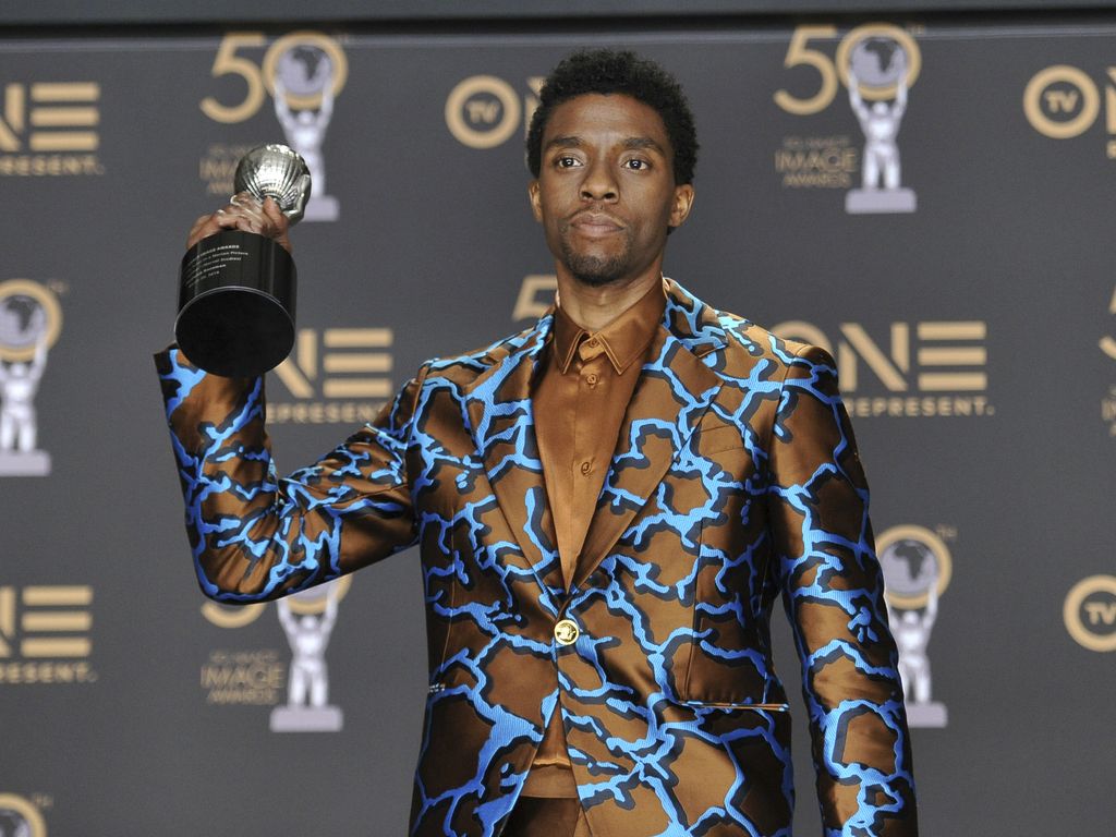 FILE - In this Saturday, March 30, 2019 file photo, Chadwick Boseman poses in the press room with the award for outstanding actor in a motion picture for 