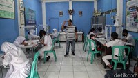 Para siswa mengikuti pelajaran online dengan mendapat pengawasan dari petugas.