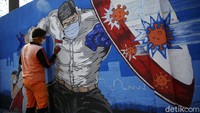 Salah satu mural menggambarkan perlawanan terhadap virus Corona.