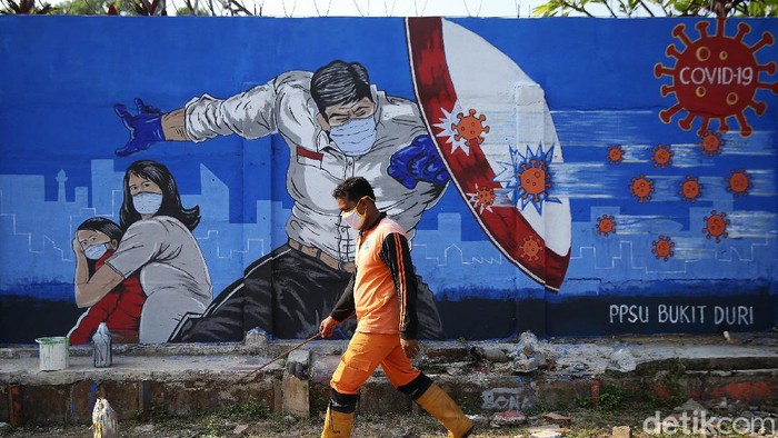 Petugas PPSU Bukit Duri menyelesaikan pembuatan mural yang berisi pesan waspada penyebaran virus Corona di kawasan Bukit Duri, Jakarta, Senin (31/8/2020). Mural tersebut dibuat agar meningkatkan kepatuhan masyarakat dalam menerapkan protokol kesehatan saat beraktivitas karena masih tingginya angka kasus COVID-19. Jumlah kasus harian Corona di DKI Jakarta pada minggu 30 Agustus 2020 memecahkan rekor dan menembus lebih dari 1.100 kasus per hari.