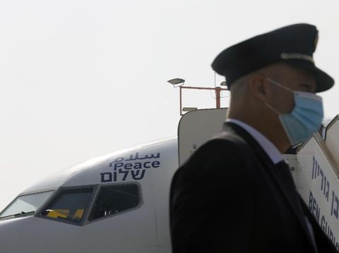 People including flight crew members are seen in the Israeli flag carrier El Al's airliner which will carry Israeli and U.S. delegations to Abu Dhabi for talks meant to put final touches on the normalization deal between the United Arab Emirates and Israel, at Ben Gurion International Airport, near Tel Aviv, Israel Monday, Aug. 31, 2020. (Nir Elias/Pool Photo via AP)