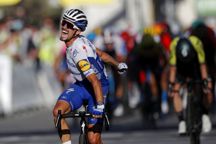 France's Benoit Cosnefroy, wearing red dots jersey of best climber celebrates on podium after winning the second stage of the Tour de France cycling race over 186 kilometers (115,6 miles) with start and finish in Nice, southern France, Sunday, Aug. 30, 2020. (Stuart Franklin/Pool photo via AP)