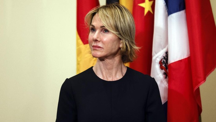 U.S. Ambassador to the United Nations Kelly Craft listens as Secretary of State Mike Pompeo speaks to reporters following a meeting with members of the U.N. Security Council, Thursday, Aug. 20, 2020, at the United Nations. The Trump administration has formally notified the United Nations of its demand for all U.N. sanctions on Iran to be restored, citing significant Iranian violations of the 2015 nuclear deal. (Mike Segar/Pool via AP)