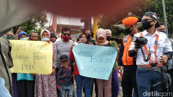Puluhan warga Lingkungan Ngegong, Kelurahan Gedog, Kecamatan Sananwetan demo di perlintasan kereta tanpa palang pintu. Mereka menolak wacana Daop 7 Madiun yang akan menutup lintasan sebidang itu.