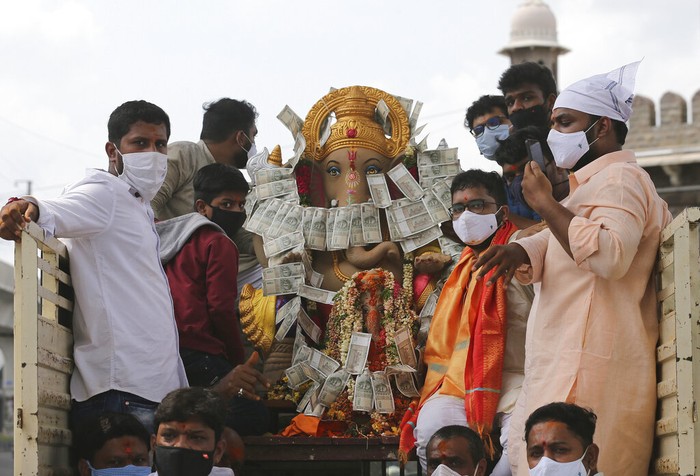 Indian workers remove idols of elephant-headed Hindu god Ganesha that were immersed earlier in  Saroornagar Lake on the final day of Ganesh Chaturthi festival in Hyderabad, India, Tuesday, Sept. 1, 2020. The festival is a celebration of the birth of Ganesha, the Hindu god of wisdom, prosperity and good fortune. (AP Photo/Mahesh Kumar A.)