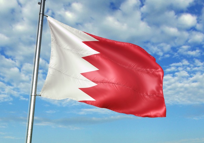 Bahrain flag on flagpole waving cloudy sky background realistic 3d illustration