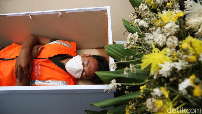 Warga yang bandel tak pakai masker diberi sanksi dengan dimasukkan ke dalam peti mati di Kalisari, Jakarta Timur, Kamis (3/9/2020).
