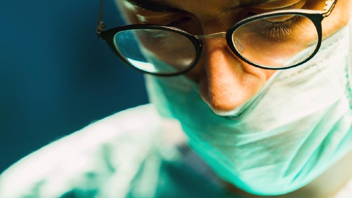 Close-up portrait of doctor in hospital operating room