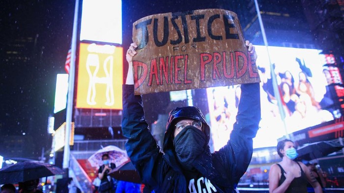 A demonstrator holds a sign during a protest to demand justice for Daniel Prude, on September 3, 2020 in New York City. - Protests were planned in New York September 3 over the death of Daniel Prude, a black man that police hooded and forced face down on the road, according to video footage that prompted a probe from the states attorney general. (Photo by Kena Betancur / AFP)