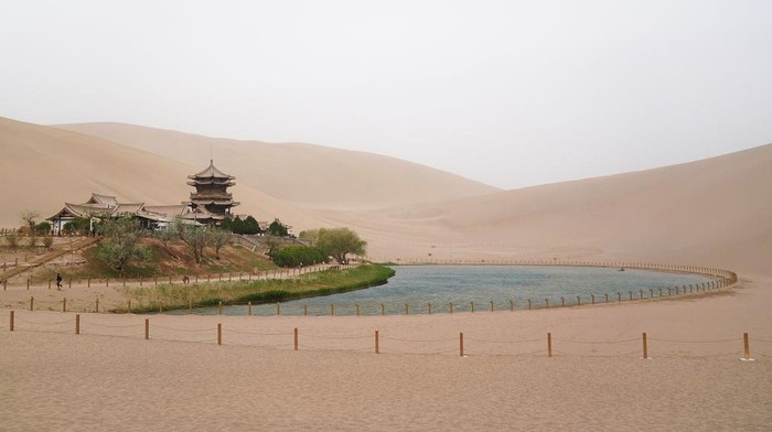 DUNHUANG , CHINA - APRIL 23:  Tourists rides on camels, walking on the desert on April 23, 2019 in Dunhuang, China. The Mingsha Shan desert (Mount Mingsha) is a part of the ancient silk road. Serving as an important platform for cultural exchange and economic cooperation among countries along the Belt and Road, Dunhuang City, which was a major stop on the ancient Silk Road. The 2nd 