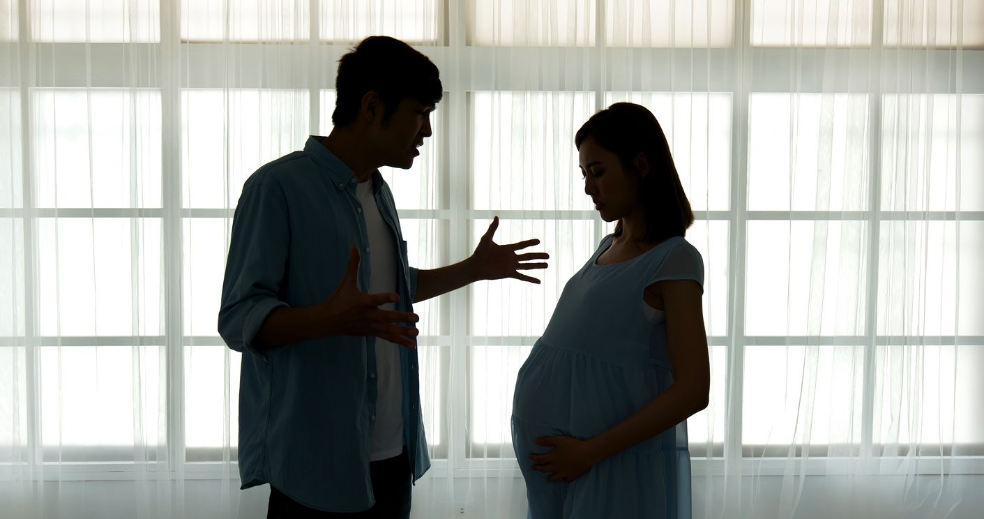 silhouette of pregnant couple arguing and quarreling at home