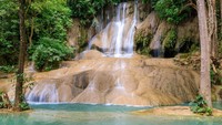 Saat berwisata dengan kereta ini, wisatawan bisa berhenti dibeberapa tempat termasuk Air terjun Sai Yok. (Getty Images/iStockphoto)
