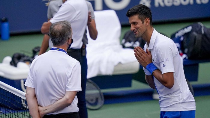 Novak Djokovic, of Serbia, leaves the court after defaulting the match to Pablo Carreno Busta, of Spain, during the fourth round of the US Open tennis championships, Sunday, Sept. 6, 2020, in New York. Djokovic inadvertently hit a line judge with a ball after hitting it in reaction to losing a point against Carreno Busta. (AP Photo/Seth Wenig)