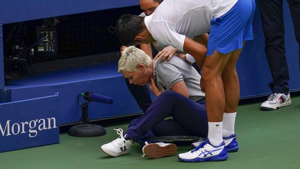 Novak Djokovic, of Serbia, checks a linesman after hitting her with a ball in reaction to losing a point to Pablo Carreno Busta, of Spain, during the fourth round of the US Open tennis championships, Sunday, Sept. 6, 2020, in New York. Djokovic defaulted the match. (AP Photo/Seth Wenig)