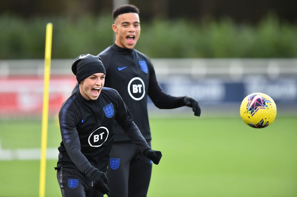 Phil Foden, Mason Greenwood BURTON-UPON-TRENT, ENGLAND - NOVEMBER 11: Phil Foden and Mason Greenwood of England U21s takes part in a training session at St Georges Park on November 11, 2019 in Burton-upon-Trent, England. (Photo by Nathan Stirk/2019 Getty Images)