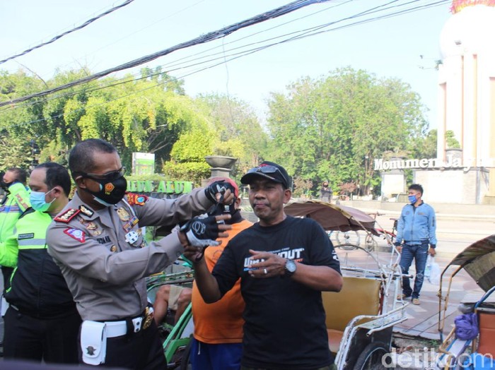 Polda Jatim Bagikan Ratusan Masker Cegah Penyebaran COVID-19