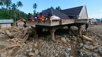 Meskipun demikian, sejumlah bocah tetap asyik makan di atas atap rumah usai bencana banjir dan tanah longsor di Desa Mamungaa Timur, Kecamatan Bulawa, Kabupaten Bone Bolango, Gorontalo, Kamis (10/9/2020).