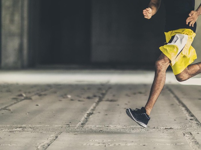 lari running Man of african descent running in an empty concrete building